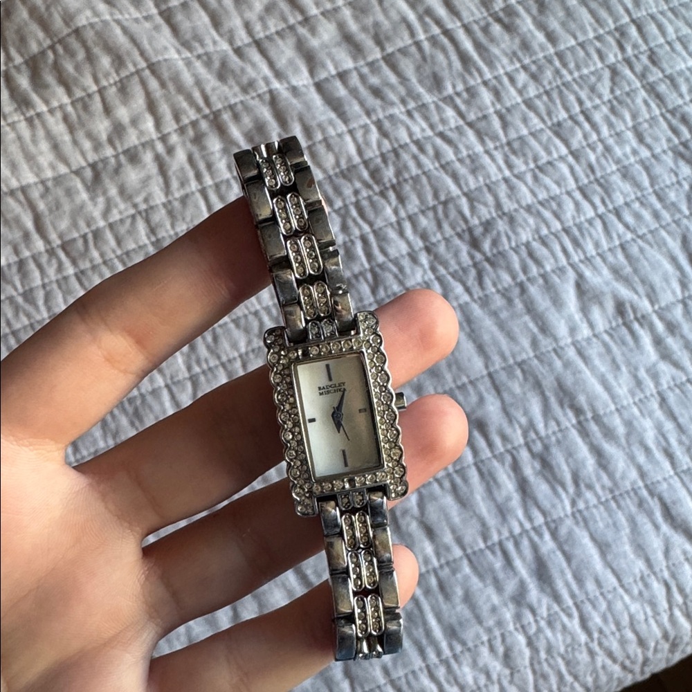 Badgley Mischka. Silver and Black Rectangular Watch. front gemstone missing.